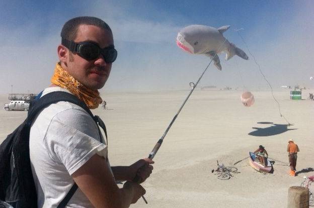 In this file photo the author of the below weblog posting goes fishing for inflatable sharks at Burning Man 2011